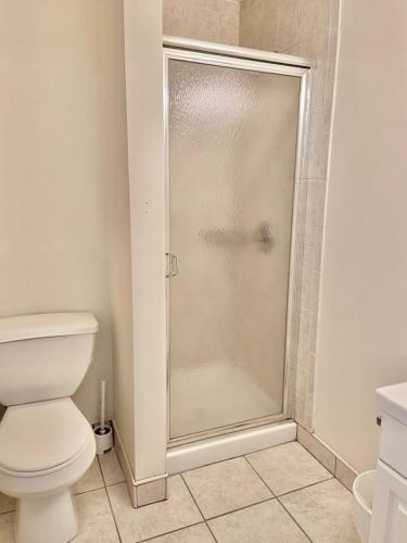 a shower stall in a bathroom with a toilet at 227-Stylish Apartment in the Heart of Hoboken in Hoboken