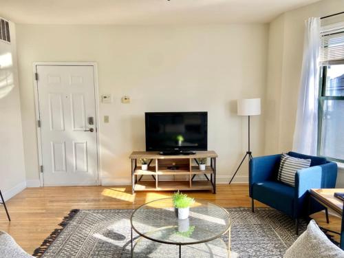 a living room with a blue couch and a tv at 0121-Bright and Spacious 2B 2B in Hoboken