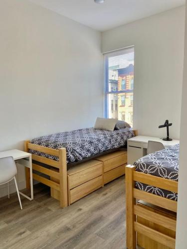 a bedroom with two beds and a window at 315-4Bedroom 2Bath W In Unit Washer in Hoboken