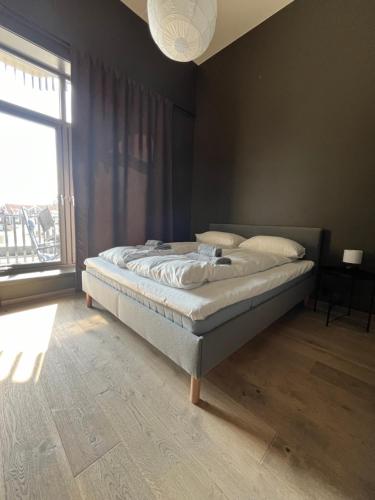 a bed in a bedroom with a large window at Trysil Alpine Lodge in Trysil