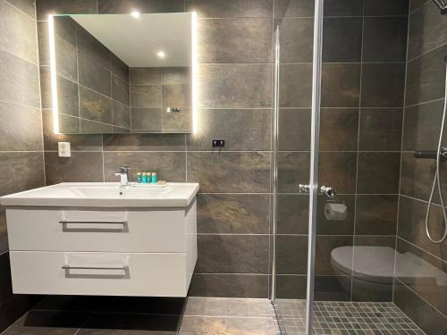 a bathroom with a sink and a shower at Trysil Alpine Lodge in Trysil