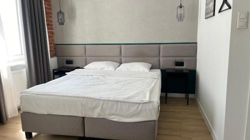 Łóżko lub łóżka w pokoju w obiekcie Kamienica Łódzka