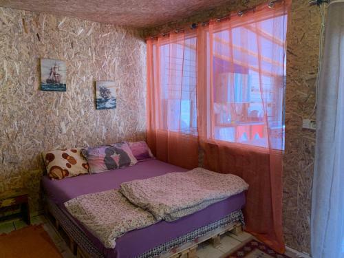 a small bed in a room with a window at Ada Bojana kucica na vodi in Ulcinj