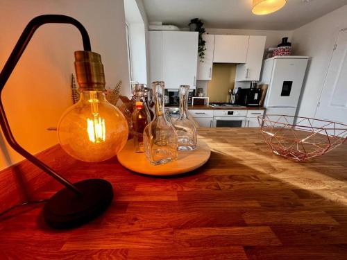 a group of glass bottles on a counter in a kitchen at Two bedroom apartment in Barry-close to beach in Barry