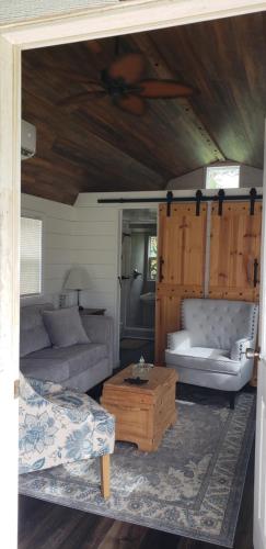 a living room with two couches and a coffee table at Tiny Paradise Escape llc in Howey in the Hills