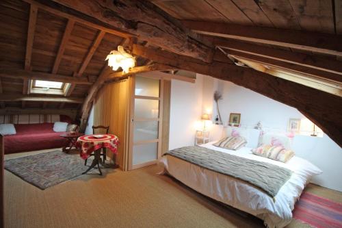 a bedroom with a bed in an attic at Kernad in Bersac-sur-Rivalier