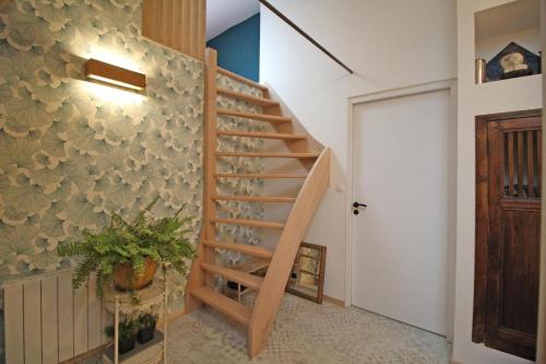 a staircase with wine glasses on the wall at Kernad in Bersac-sur-Rivalier