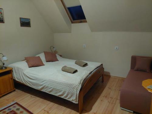a bedroom with a bed with two pillows on it at Magnolia Gospodarstwo Agroturystyczne in Kazimierz Dolny