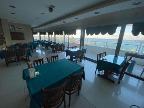 a restaurant with tables and chairs and a view of the ocean at Ganita Life Hotel in Trabzon