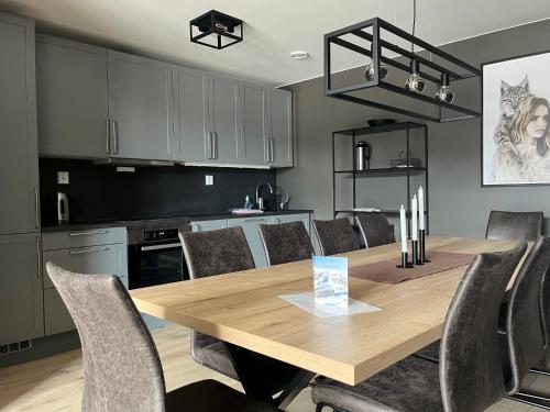 a kitchen with a wooden table and chairs at Trysil Alpine Lodge in Trysil