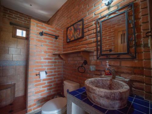 a bathroom with a stone sink in a brick wall at 2 bedroom apartment with bay view, deck and roof terrace in San Juan del Sur
