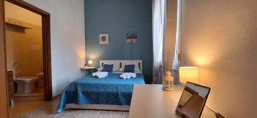 - une chambre avec un lit bleu et une table avec un ordinateur portable dans l'établissement Sea Room Aspra B&B, à Bagheria