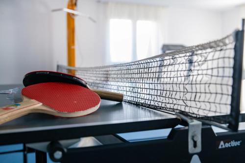 a tennis racket sitting on top of a table at Zsóry Liget Hotel & Spa Superior in Mezőkövesd