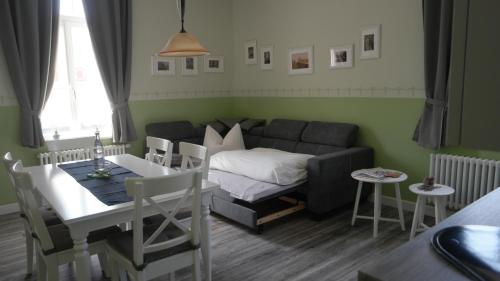 a living room with a couch and a table at Appartements Neef in Merseburg