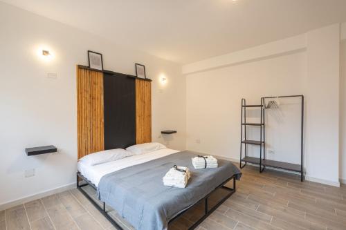 a bedroom with a bed with two bags on it at Cavour Home in Porto Torres