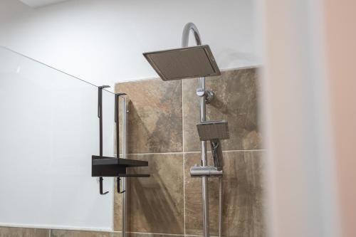 a shower with a shower head in a bathroom at Cavour Home in Porto Torres