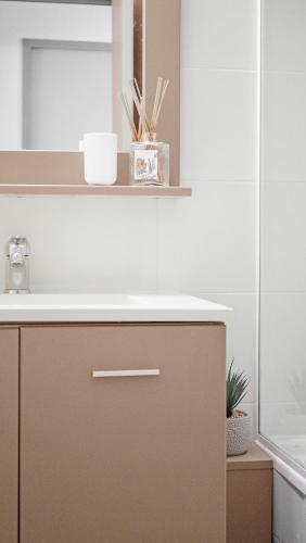 une salle de bain avec un lavabo et un miroir dans l'établissement Le PTIT DOUMÉ, Plage - Piscine, à Gassin