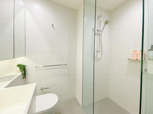 a bathroom with a shower and a toilet and a sink at Melbourne Luxury Apartment Steps away from Crown in Melbourne