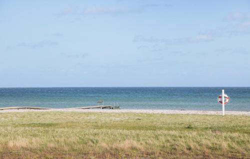 a stop sign on a beach with the ocean at Gorgeous Home In Kerteminde With Wifi in Kerteminde
