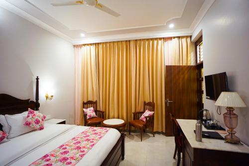 a hotel room with a bed and a desk with a telephone at Chitawa Haveli - A Luxury Heritage Hotel in Jaipur