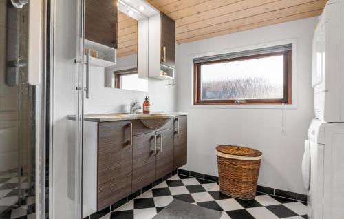 a small bathroom with a sink and a refrigerator at Nice Home In Tarm With Wifi in Tarm