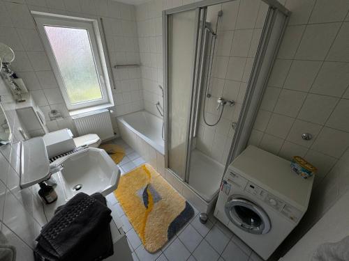 a bathroom with a shower and a washing machine at Ferienwohnung 24A Unten Links 3 Zimmer in Lathen