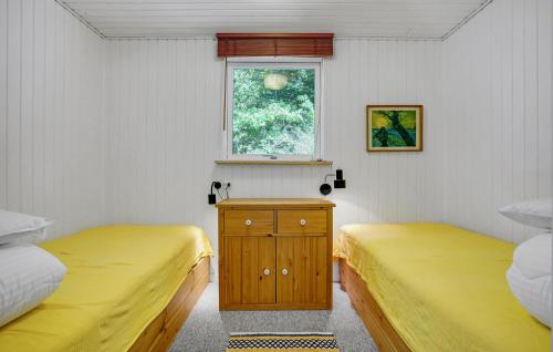two twin beds in a room with a window at 3 Bedroom Stunning Home In Ebeltoft in Ebeltoft