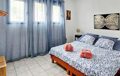 a bedroom with a bed with two shoes on it at 3 Bedroom Cozy Home In Saint-Gaultier in Saint-Gaultier