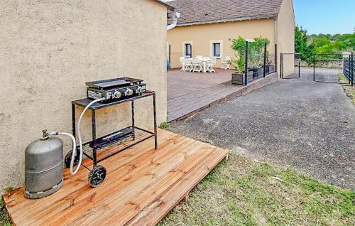 a grill on a wooden deck next to a house at 3 Bedroom Cozy Home In Saint-Gaultier in Saint-Gaultier