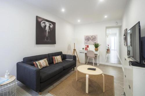 a living room with a couch and a table at ANCO 56 - Cozy Retreat with Terrace in Ponta Delgada