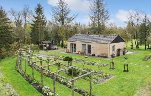 a house with a garden in front of it at Gorgeous Home In Vorbasse With Kitchen in Vorbasse