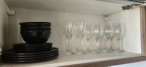 a group of wine glasses sitting on a shelf at Apê BENTO com churrasqueira! in Bento Gonçalves