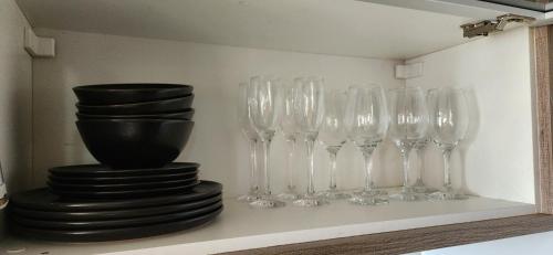 a group of wine glasses sitting on a shelf at Apê BENTO com churrasqueira! in Bento Gonçalves