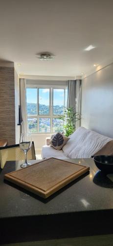 a bedroom with a large bed with a window at Apê BENTO com churrasqueira! in Bento Gonçalves