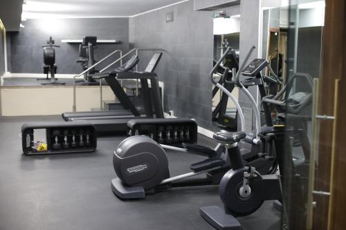 a gym with several exercise bikes in a room at Radisson Blu GHR Rome in Rome