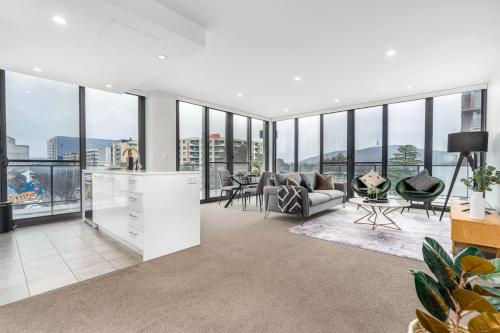 an open living room with a lot of windows at Roomy 2BR 2BA City-Centre Apt - Hosted by CanStay in Canberra