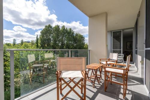 a balcony with chairs and a table and a view at Tranquil 2BR APT - Glebe Park View - Hosted by CanStay in Canberra