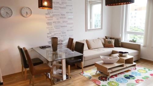 a living room with a table and a couch at Apartment in the Heart of Ostrava in Moravská Ostrava