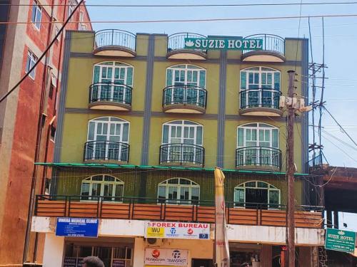 a building with balconies on the side of it at Suzie hotel old Kampala in Kampala