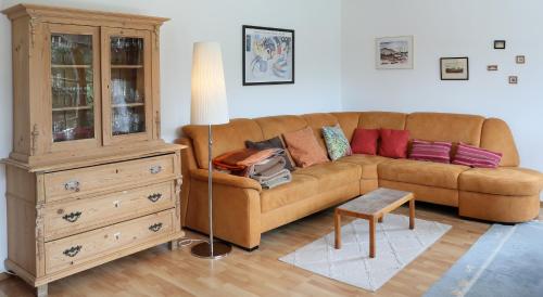 sala de estar con sofá marrón y cómoda en 90m² Top Holiday Home Upper Bavaria + Munich South, en Schäftlarn