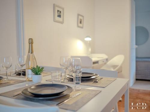 - une table avec des assiettes, des verres et une bouteille de vin dans l'établissement Le Berbisey Dijon Centre, à Dijon