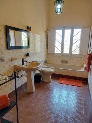 a bathroom with a sink and a toilet and a tub at Wilga Summit Apartment B in Qala