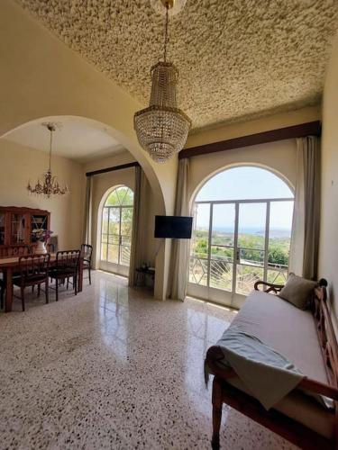 a bedroom with a bed and a dining room with a table at Wilga Summit Apartment B in Qala