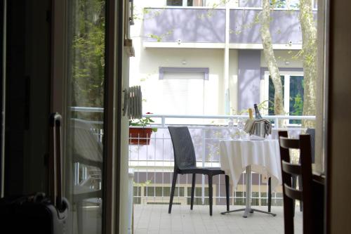 a table and chairs on a balcony with a view of a building at Blue Loft Hotel in Cesenatico