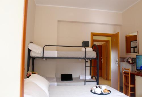 a bedroom with two bunk beds in a room at Blue Loft Hotel in Cesenatico