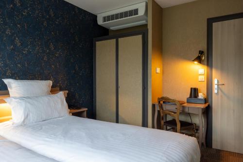 Postel nebo postele na pokoji v ubytování Hotel Restaurant Au Riesling