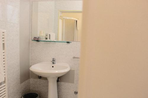 a bathroom with a sink and a mirror at Blue Loft Hotel in Cesenatico