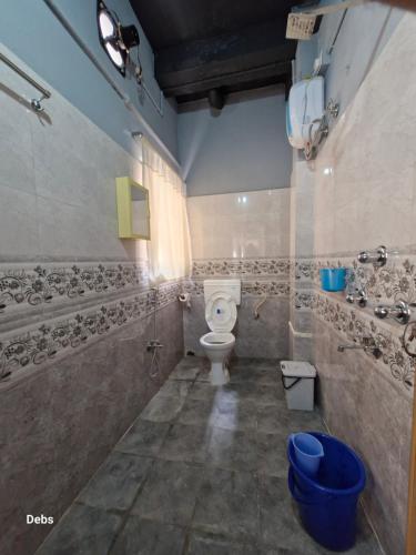 a bathroom with a toilet and a sink at FAITH in Siliguri