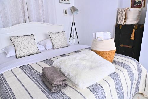 a bed with a blanket and pillows on it at Casa Fotografului in Constanţa