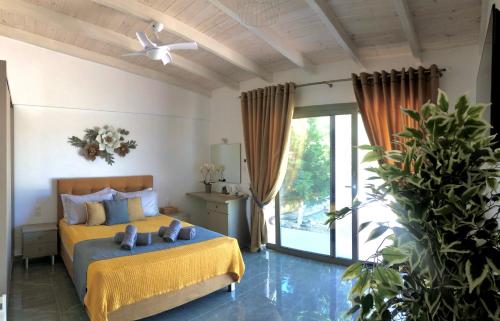 Un dormitorio con una cama amarilla y una ventana en Private Villa Freedom, en Moírai